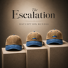 Three tan and blue baseball caps on beige stands with 'The Escalation' branding.