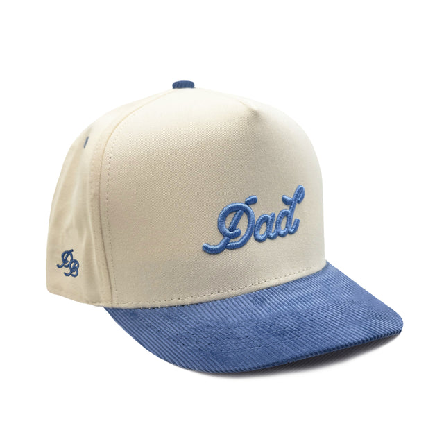 Beige and blue cap with 'Dad' embroidery on a white background
